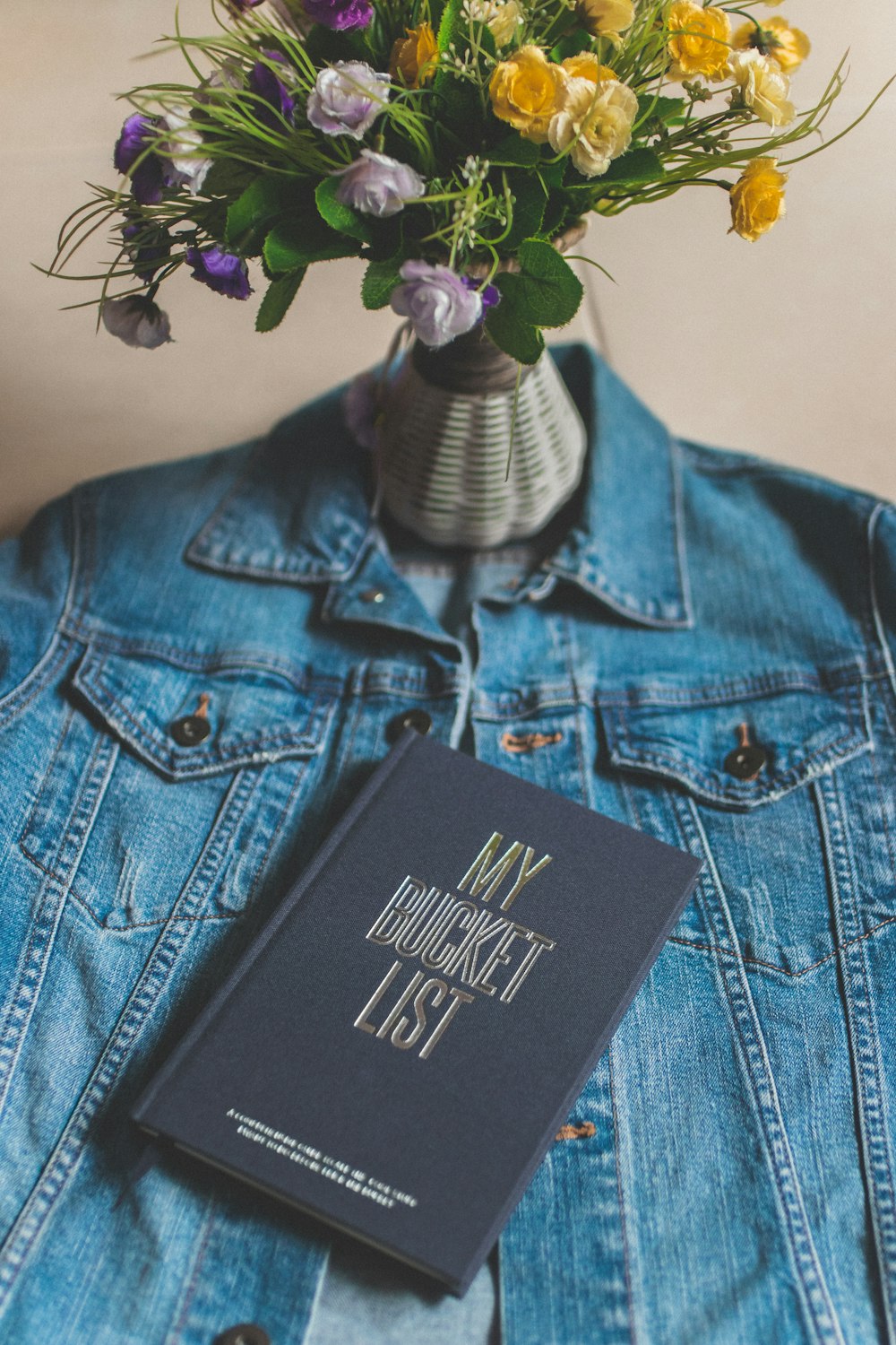 black and white calvin klein box on blue denim button up jacket