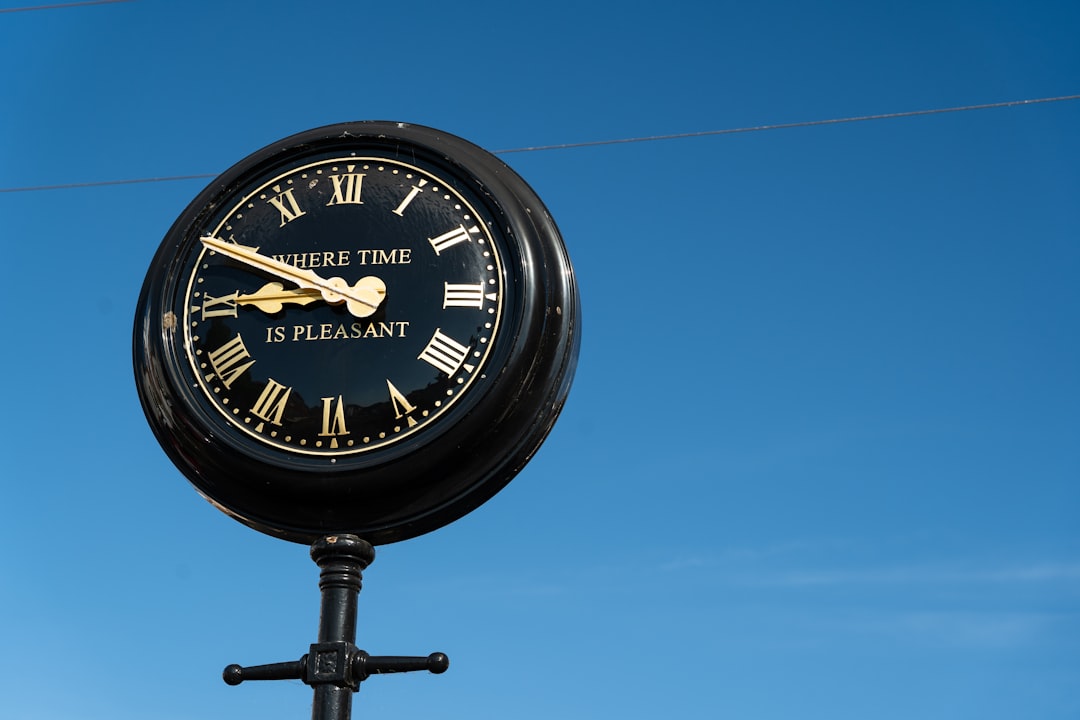 black and white analog clock at 10 00