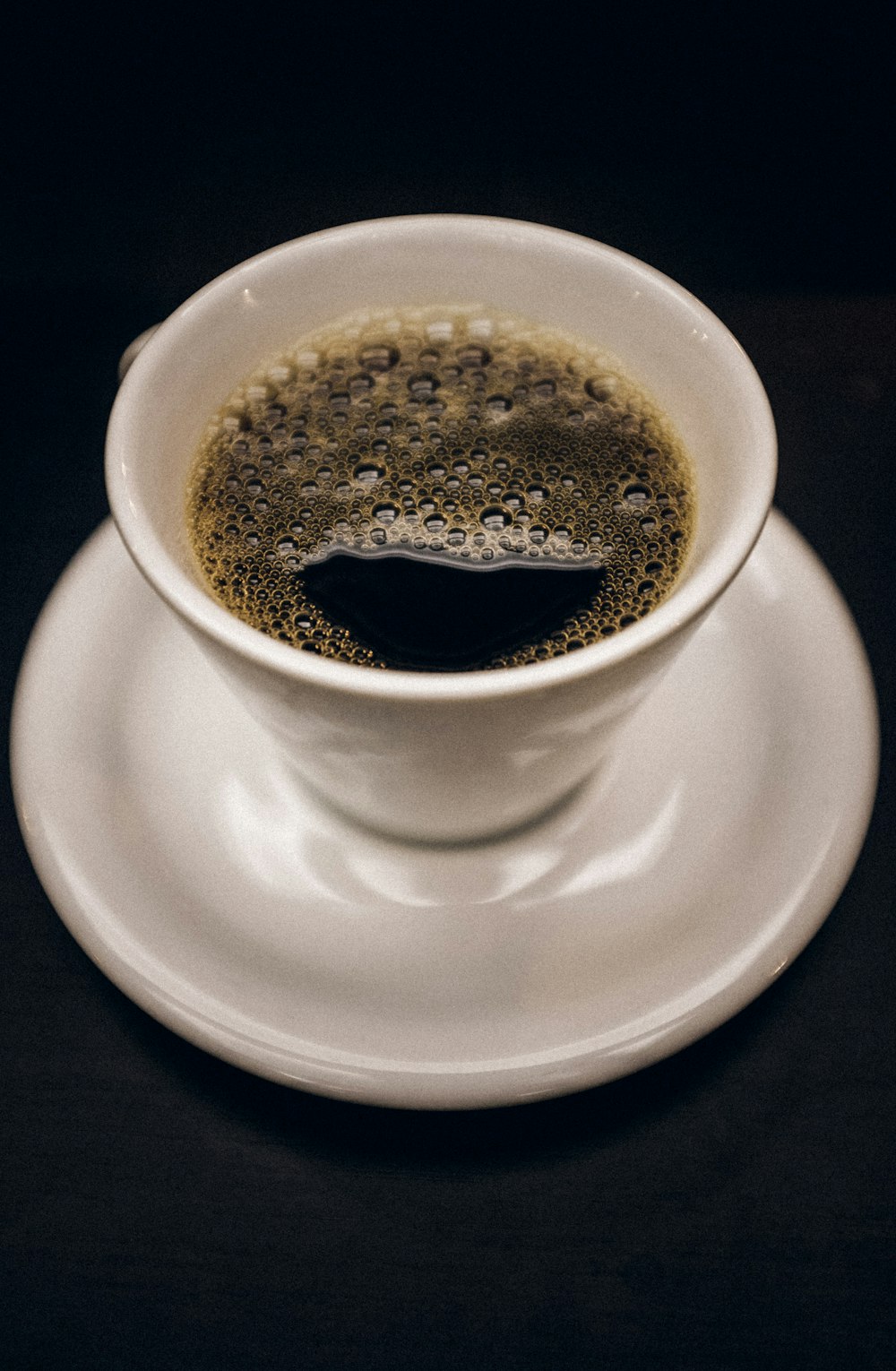 white ceramic mug with black coffee