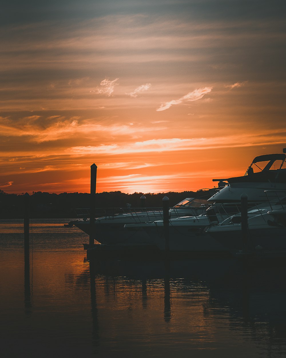 white and black boat on sea during sunset