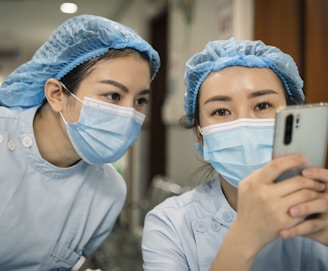 woman in white shirt wearing white mask holding iphone