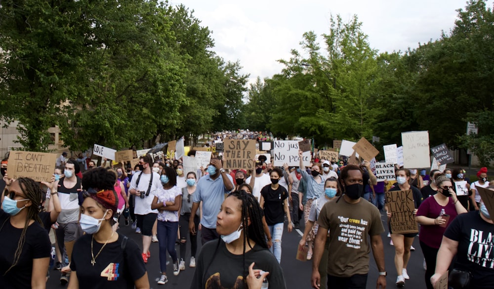 people standing on road during daytime