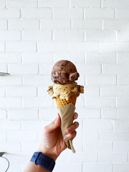 Scoop of chocolate ice cream on a cone
