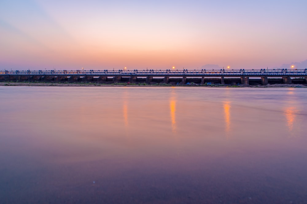 bridge over the sea during sunset