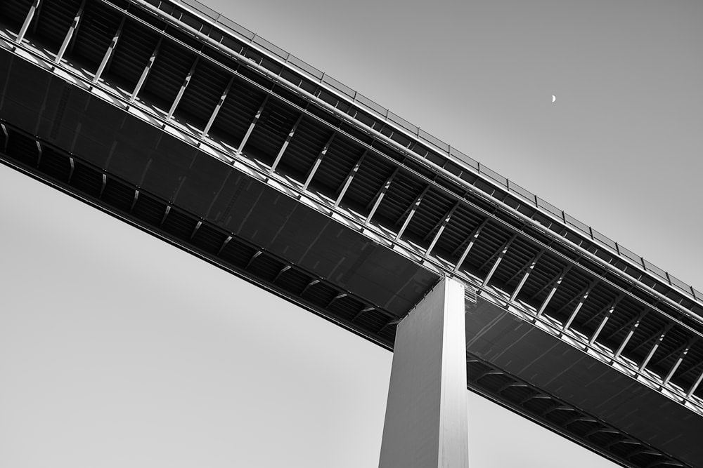 grayscale photo of concrete bridge