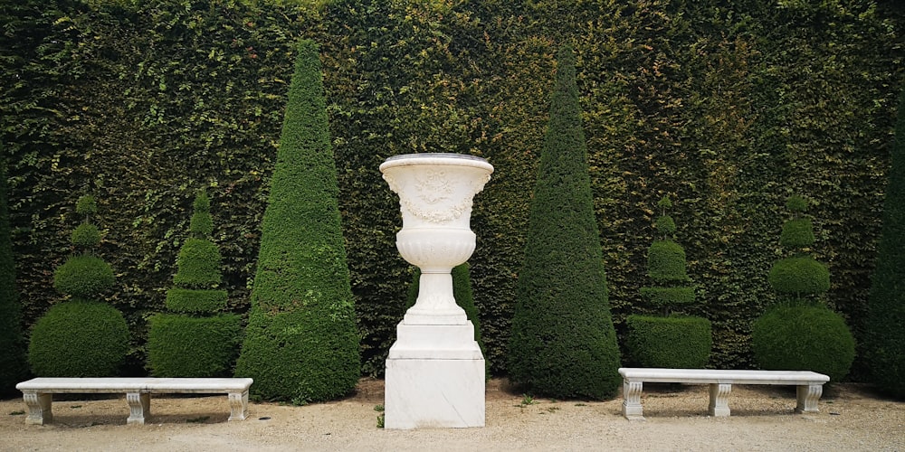 white concrete post near green grass field