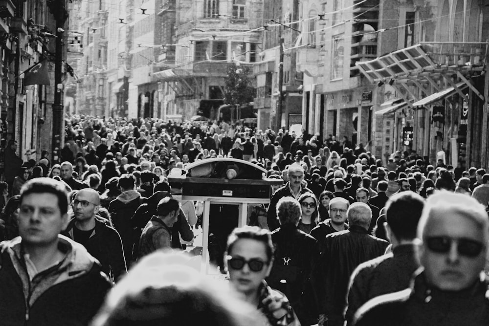 grayscale photo of people in the street