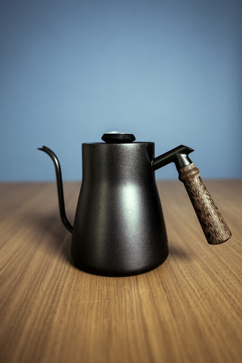 black kettle on brown wooden table