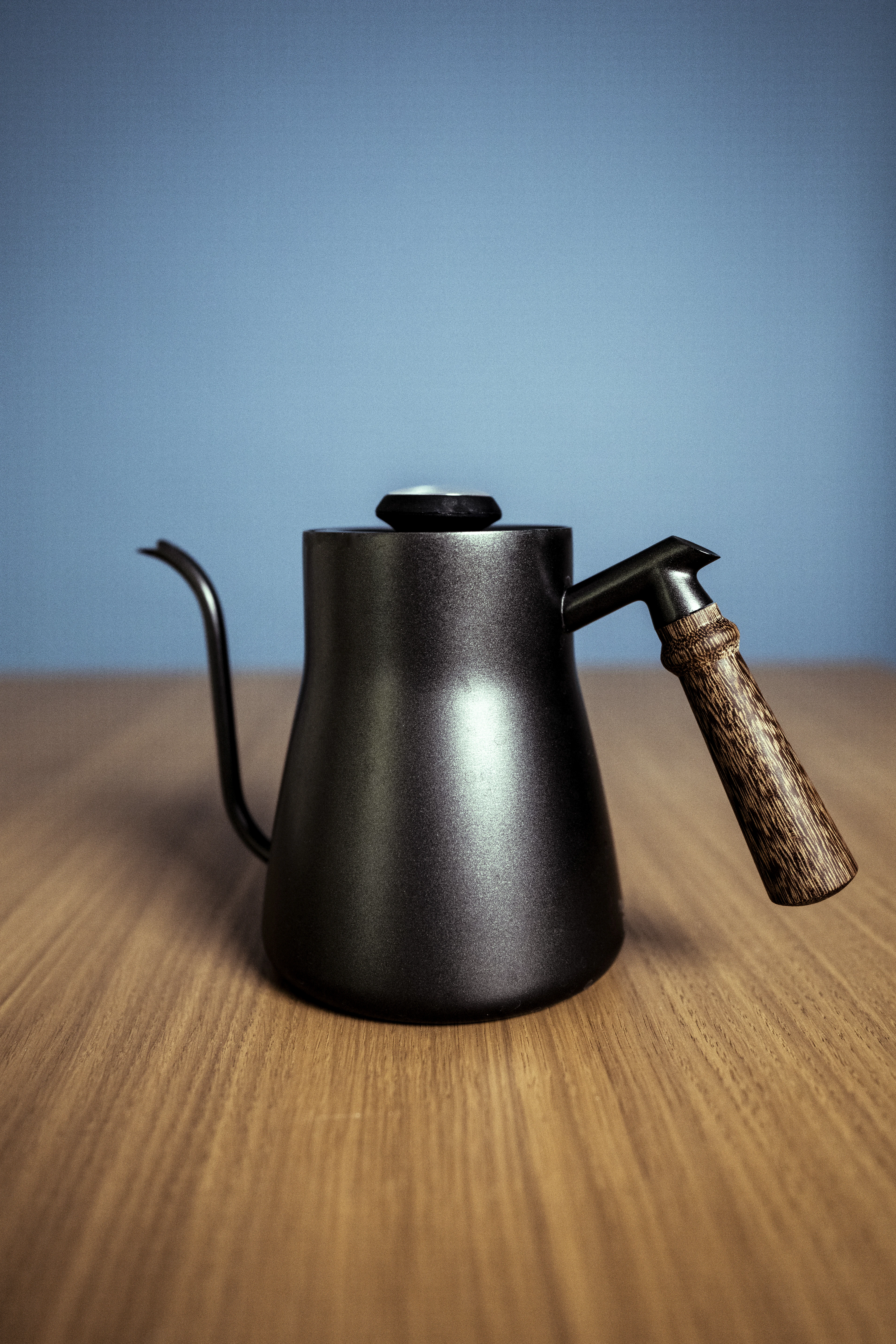 Black kettle on brown wooden table