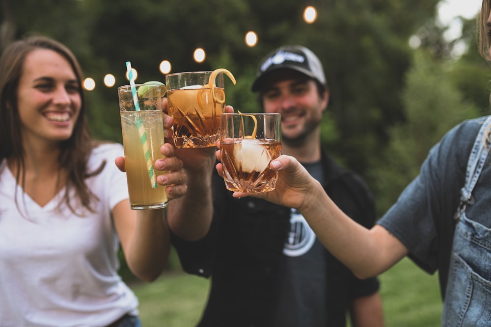 man in black crew neck t-shirt holding drinking glasses