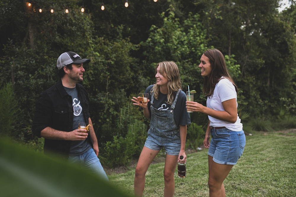 woman in black crew neck t-shirt and blue denim shorts standing beside woman in white