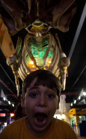 Children exploring a fossil exhibit corner inside the café with curious expressions.