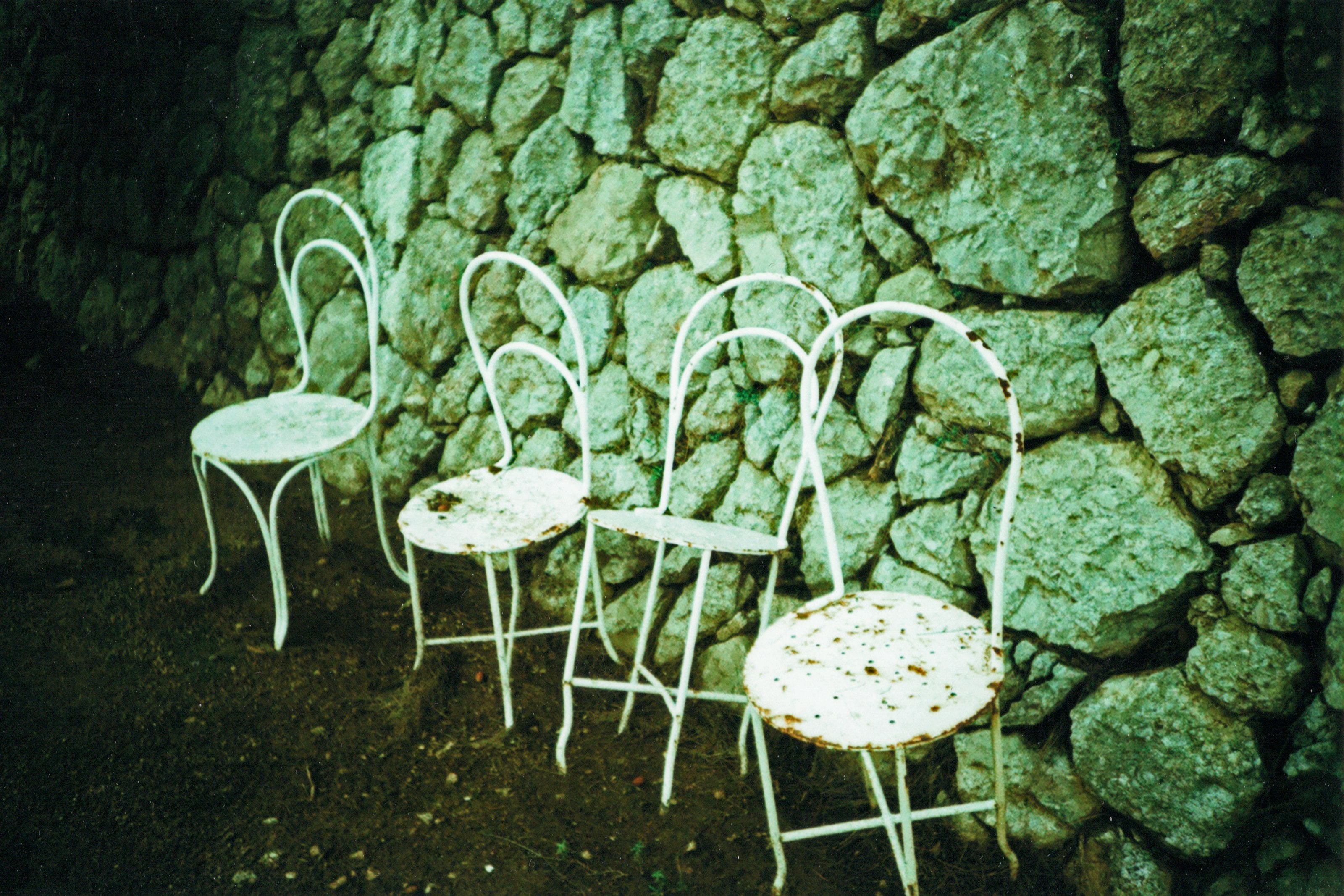 white metal chair on black soil