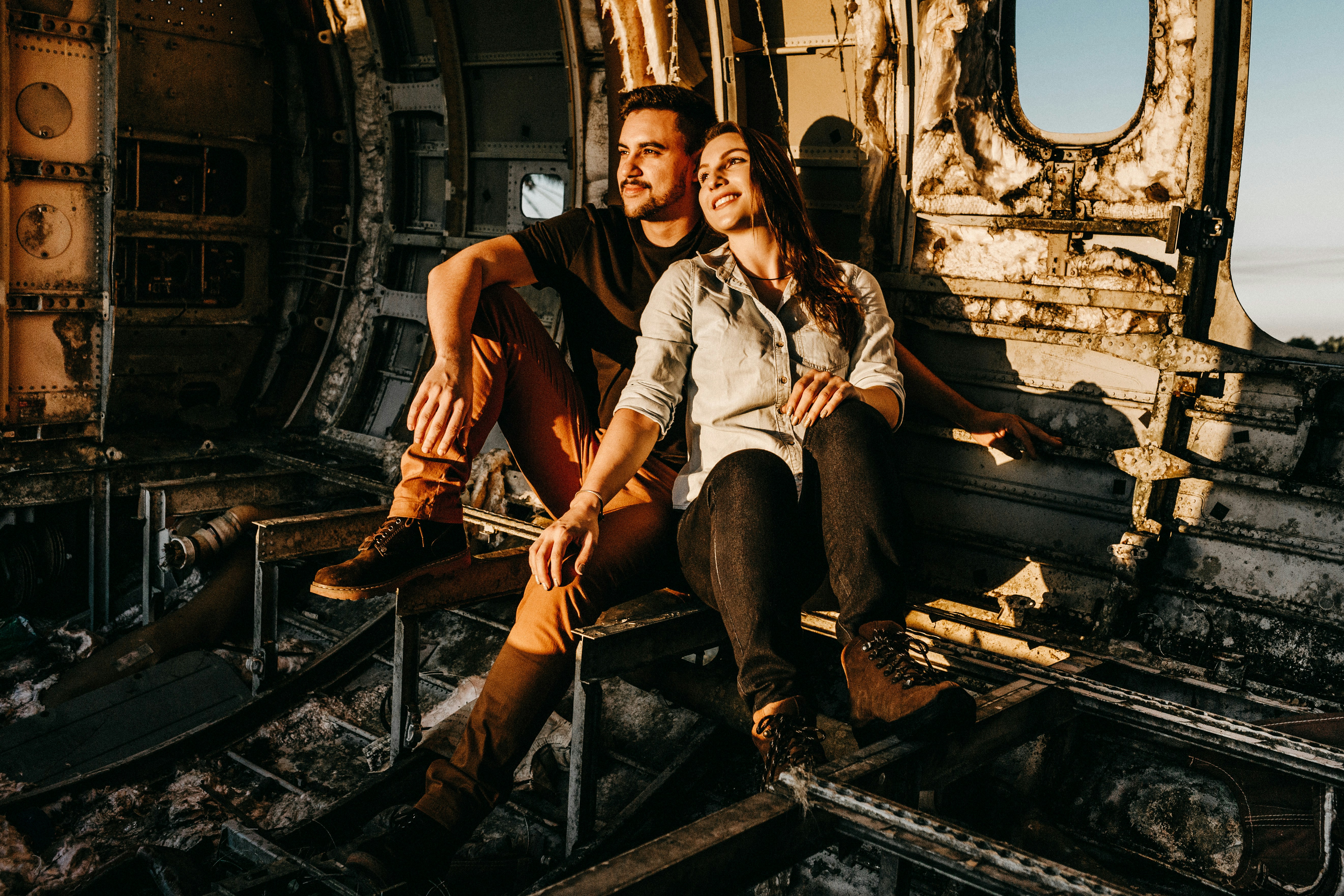 man and woman sitting on train rail during daytime, 