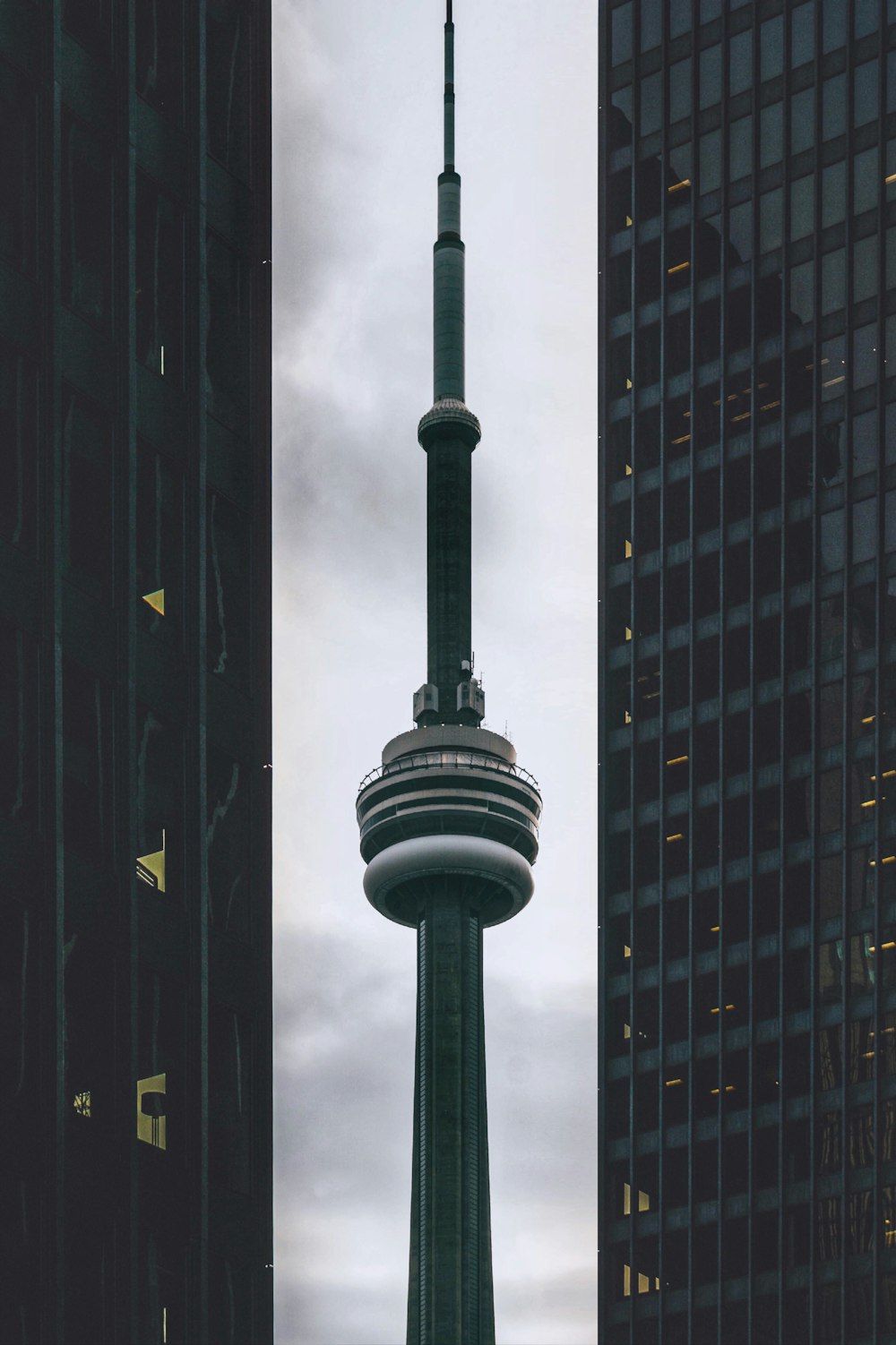 black and white tower in the middle of high rise buildings