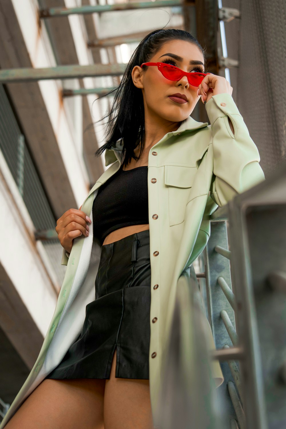 woman in beige coat and black skirt wearing sunglasses