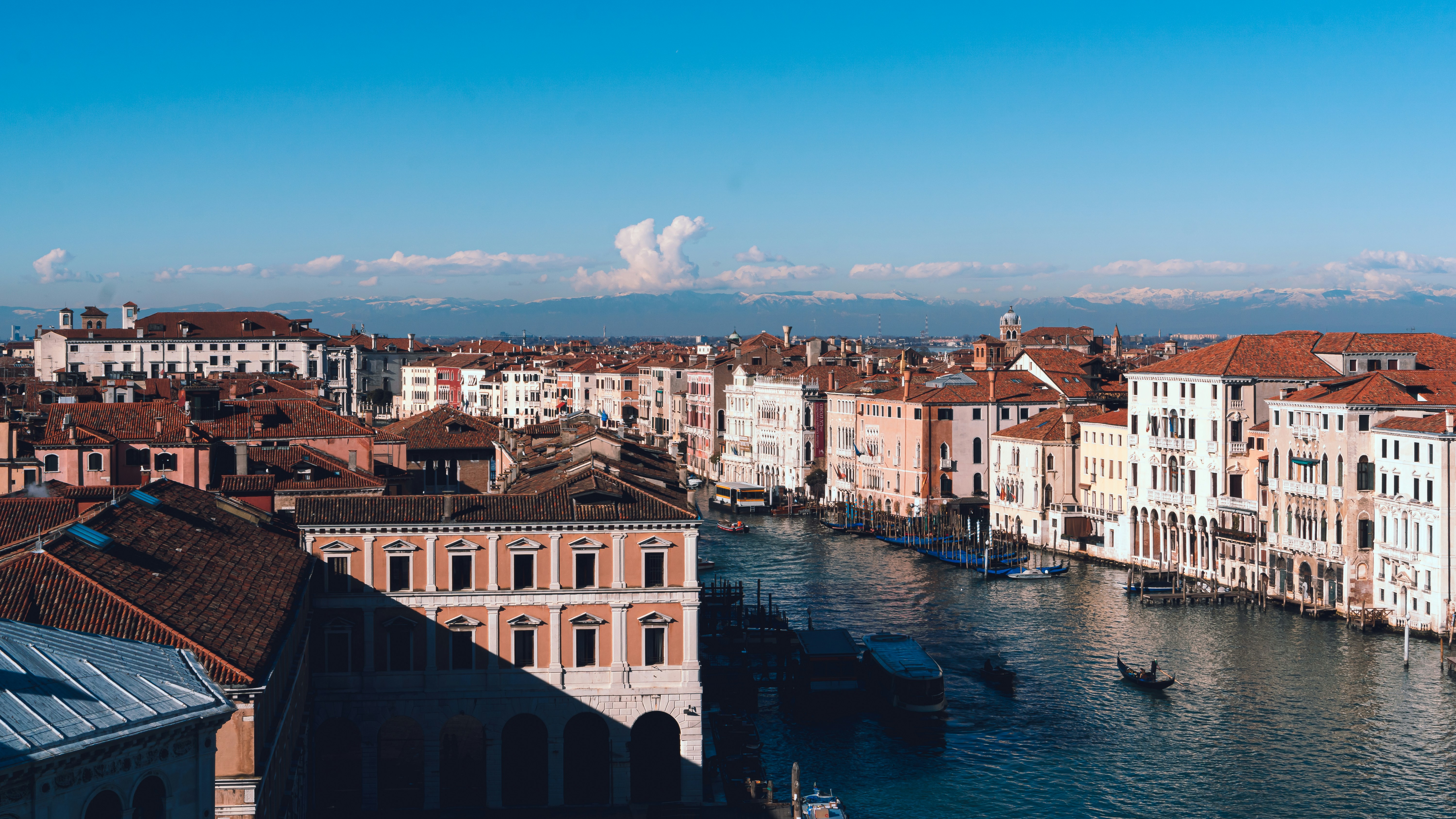 brown concrete building beside body of water during daytime