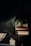 A serene setting featuring a stack of wellness books and a potted plant.