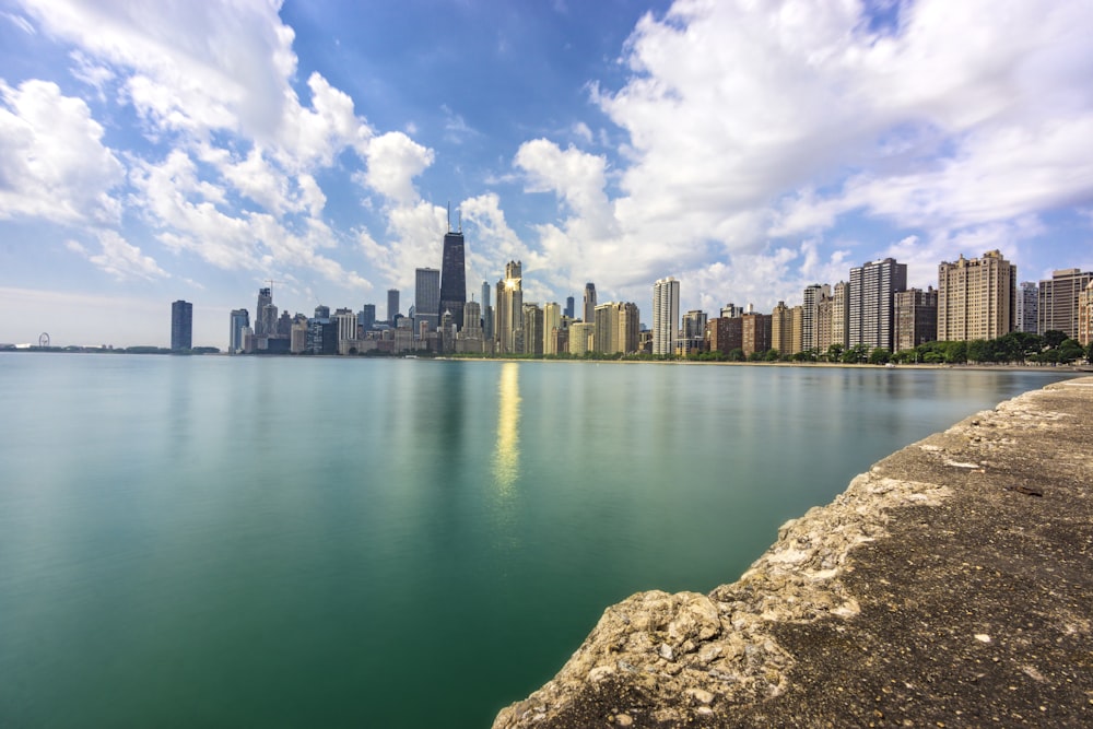 body of water near city buildings during daytime