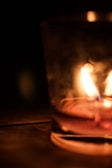 Concrete container with a lit candle inside, highlighting warm ambiance.