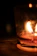 A softly lit living room corner with a Flambeau candle casting gentle shadows.