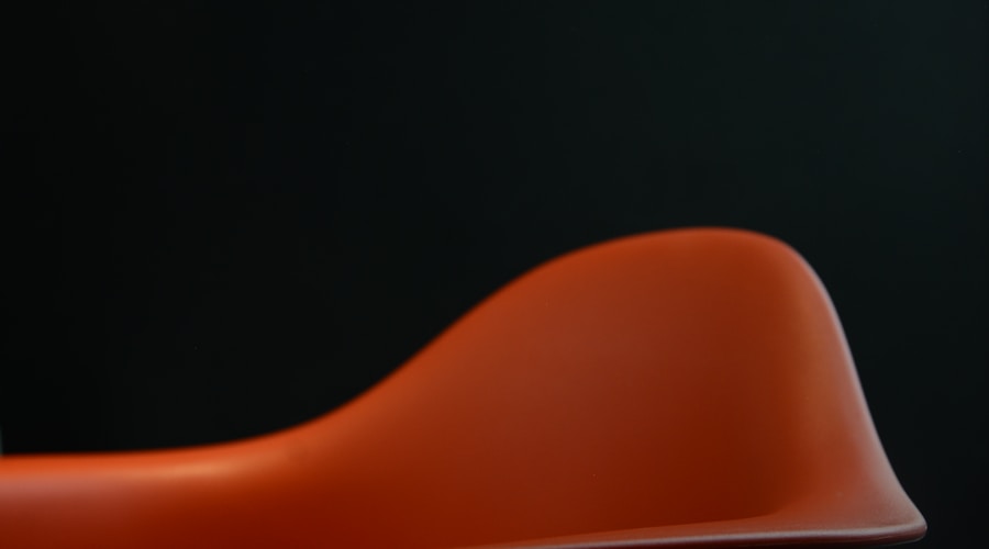red plastic chair on black background