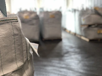 Close-up of colorful polypropylene sacks stacked neatly in a warehouse.