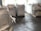 Large industrial sacks are positioned in a warehouse with a focus on one sack in the foreground and more sacks blurred in the background. The setting appears to be indoors with soft lighting, creating a sense of a spacious storage facility.