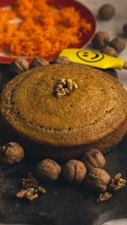 brown round cake on white and red table cloth