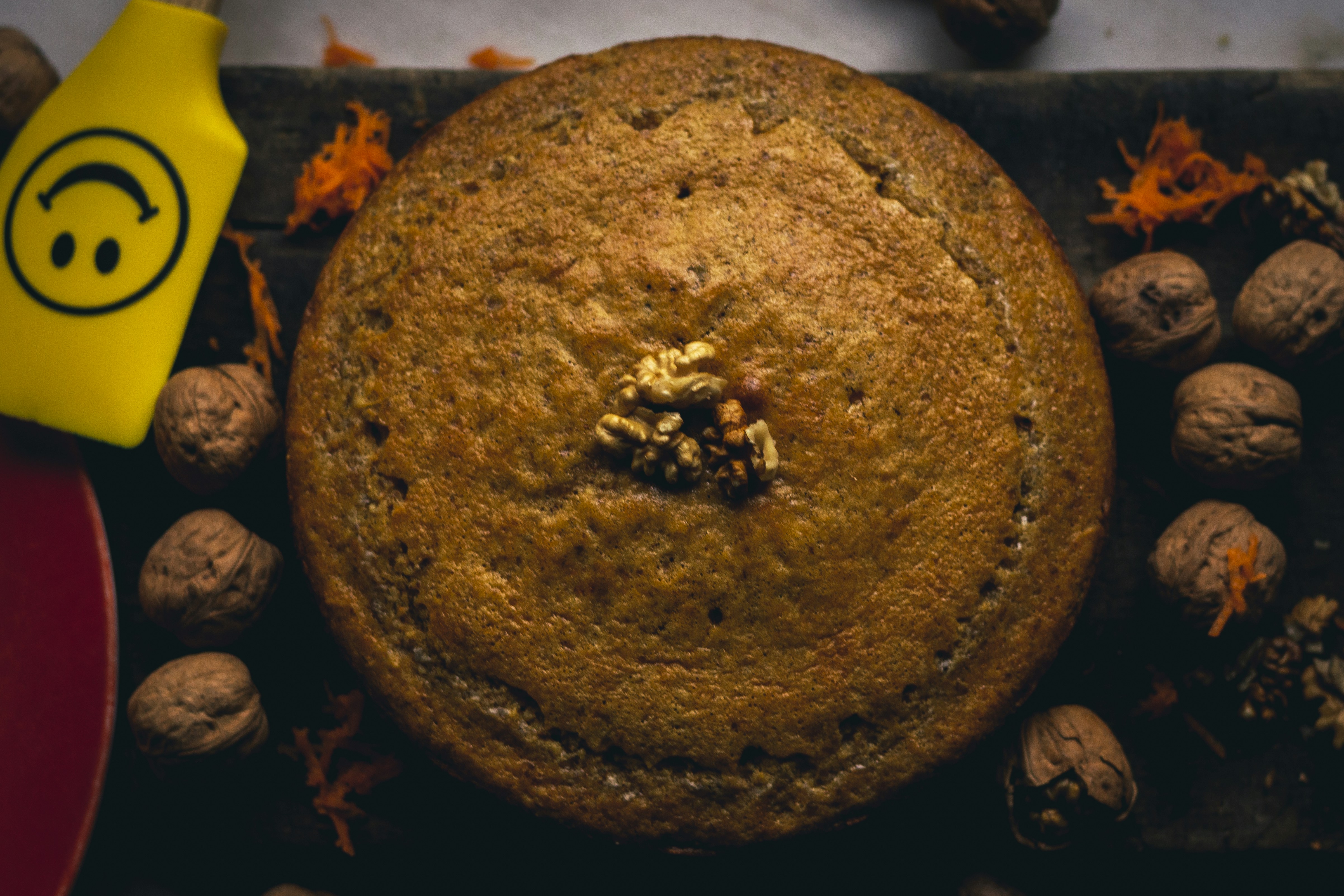 brown round fruit with black and yellow leaves
