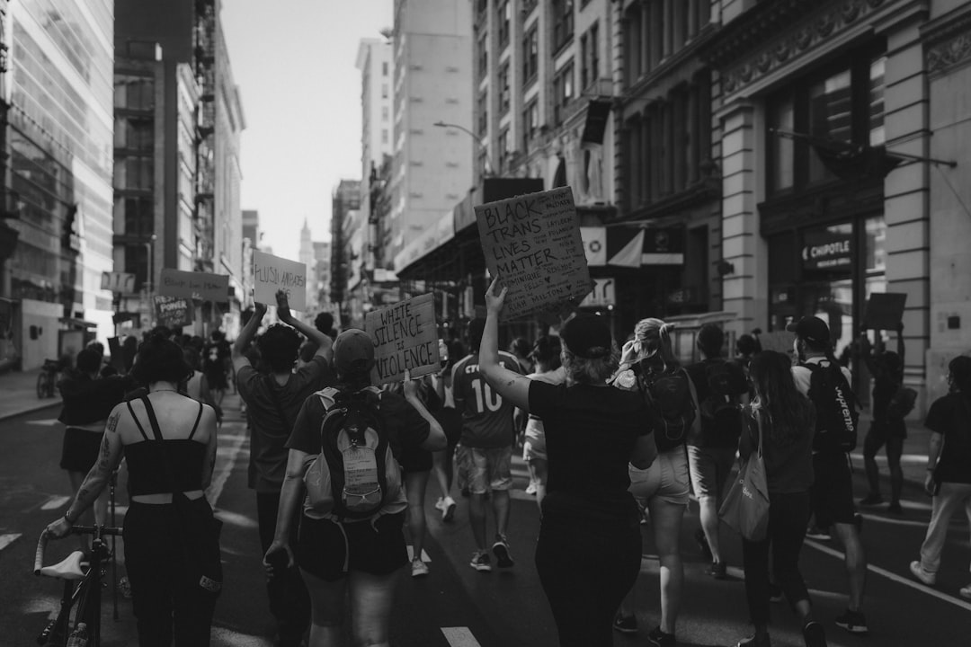grayscale photo of people walking on street,