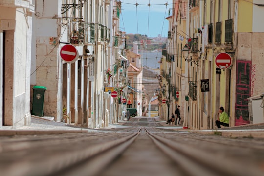 red stop sign on street during daytime in Rua da Bica Portugal