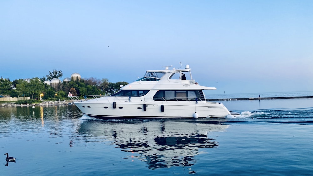 white yacht on body of water during daytime