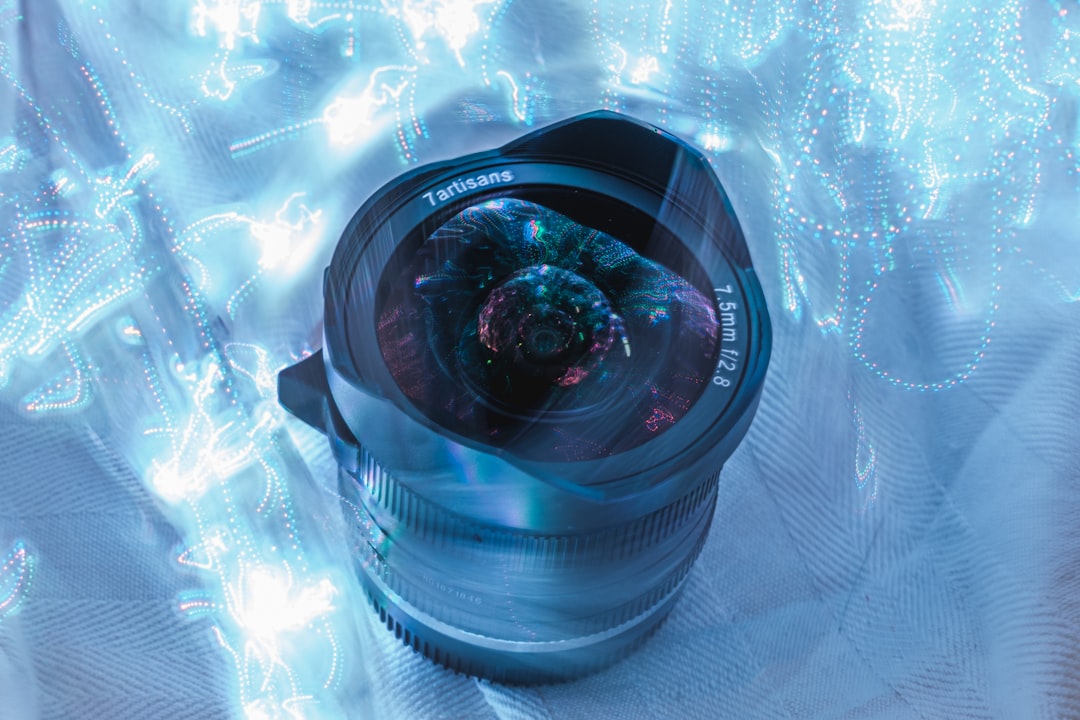 black camera lens on blue and white floral textile