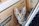 A happy cat sitting next to a clean eco-friendly cat litter box.