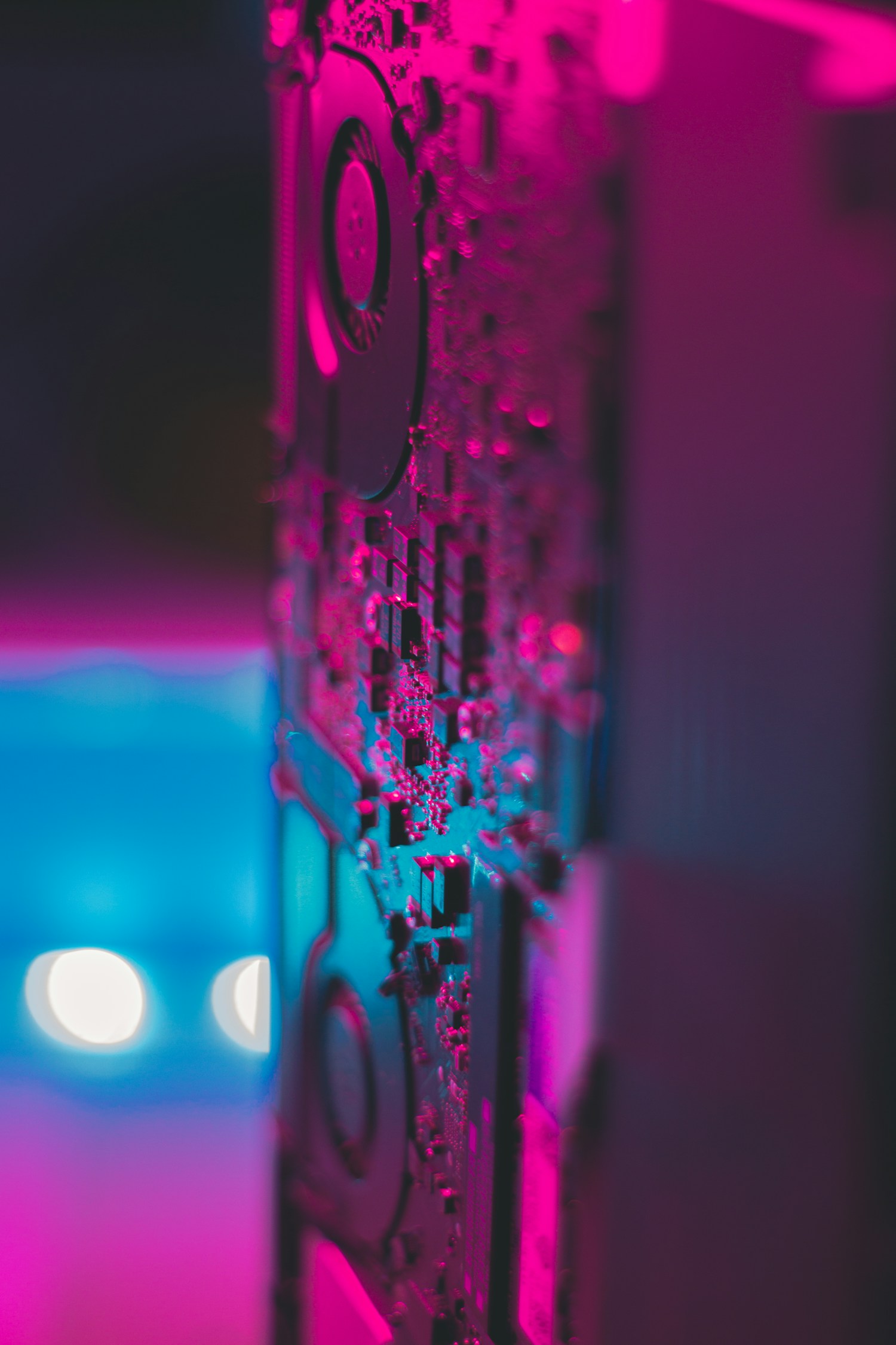 Woman using a laptop in a server room, showcasing modern technology and work environment.