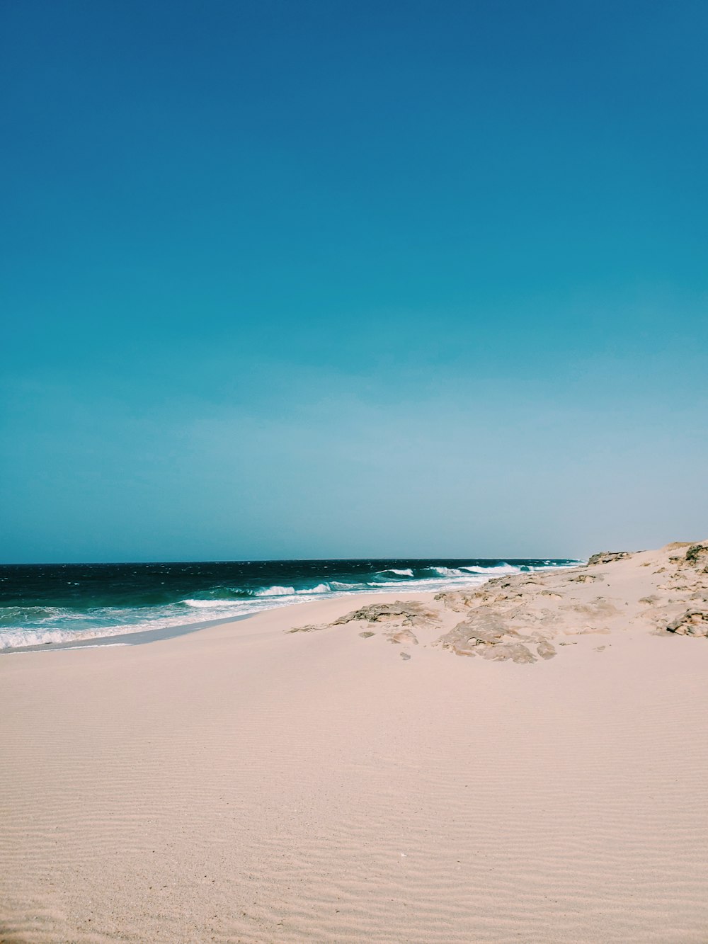 white sand beach during daytime