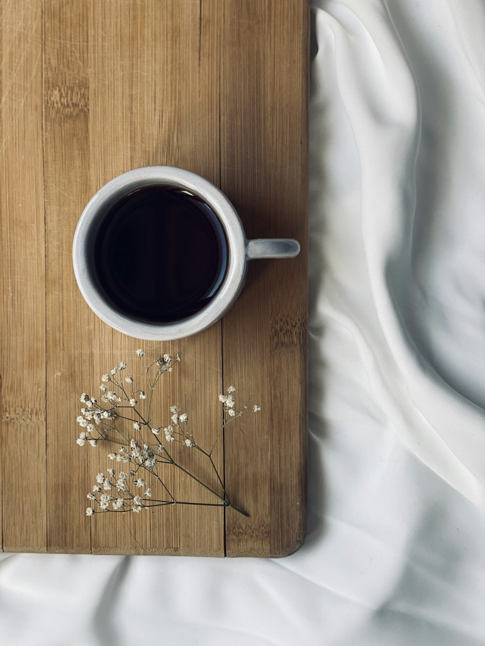 black coffee in white ceramic mug on brown wooden table