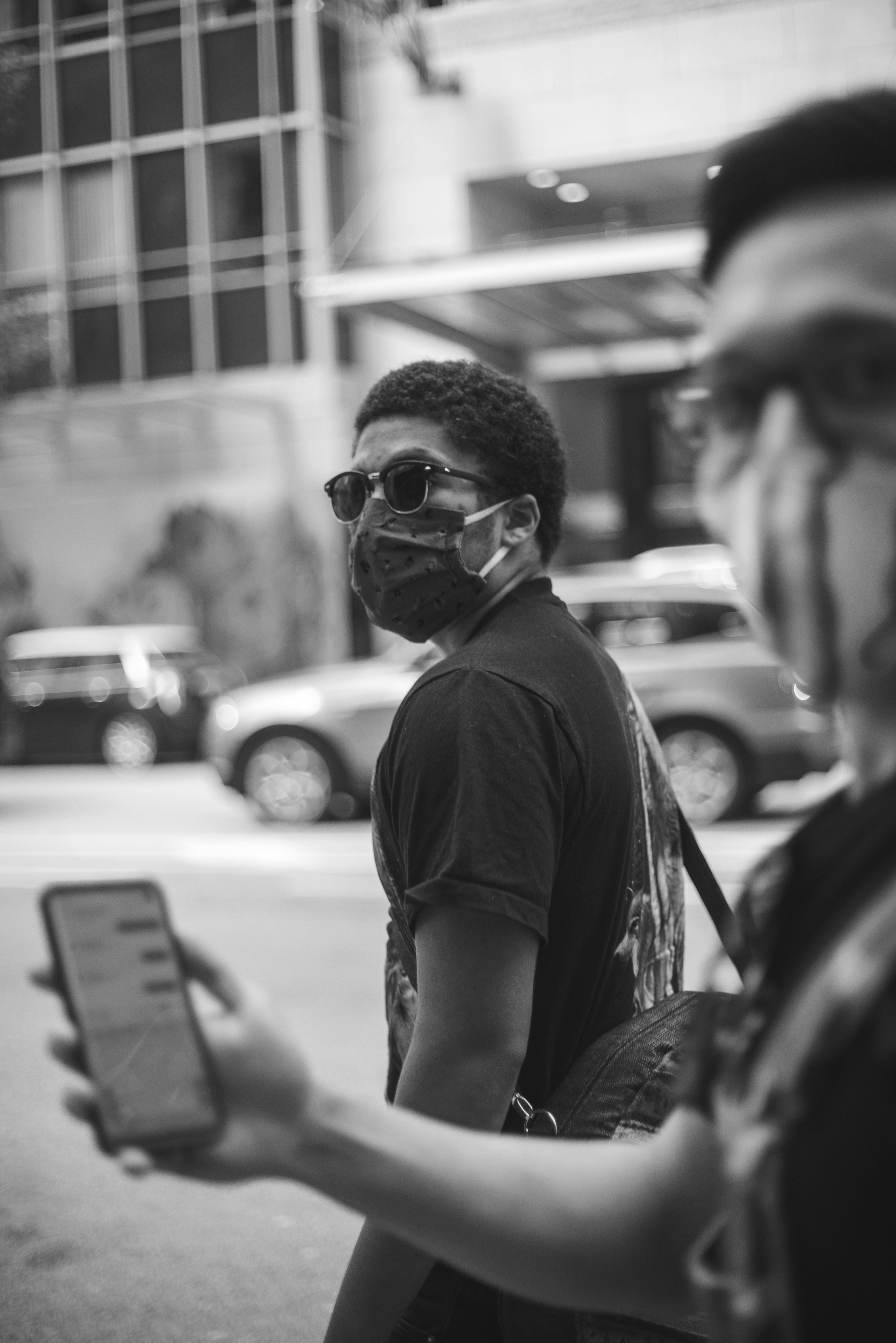 grayscale photo of man in crew neck t-shirt wearing sunglasses