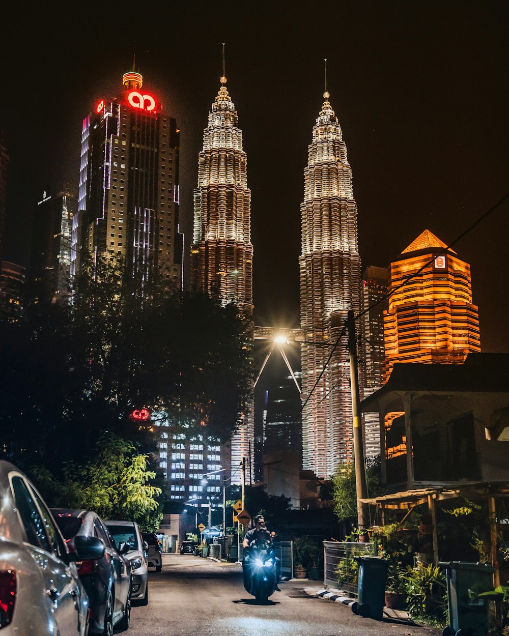 cars parked near high rise building during night time