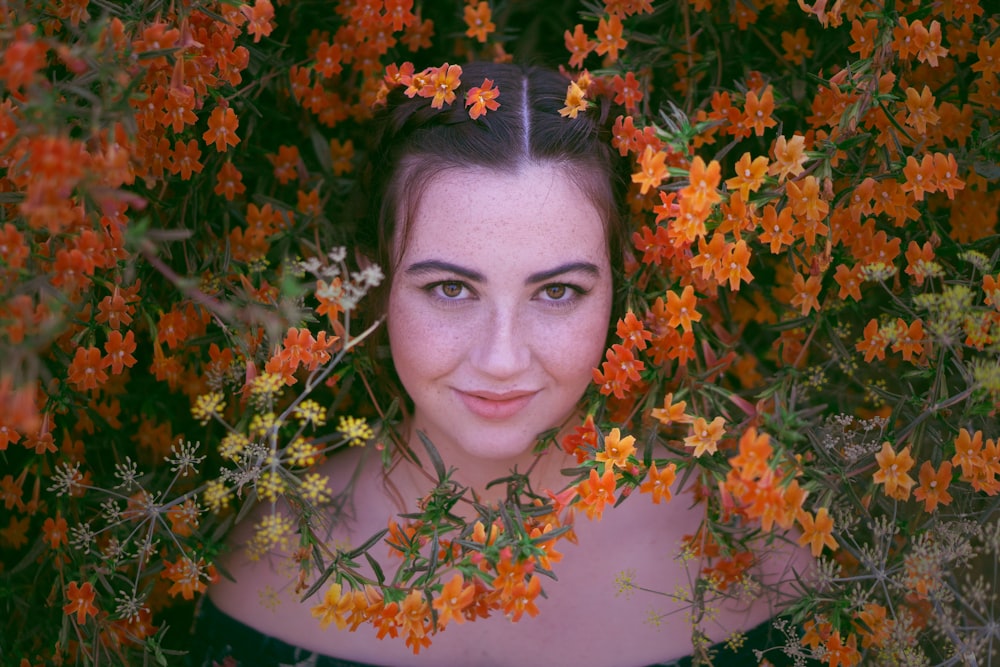 woman in black shirt surrounded by brown leaves