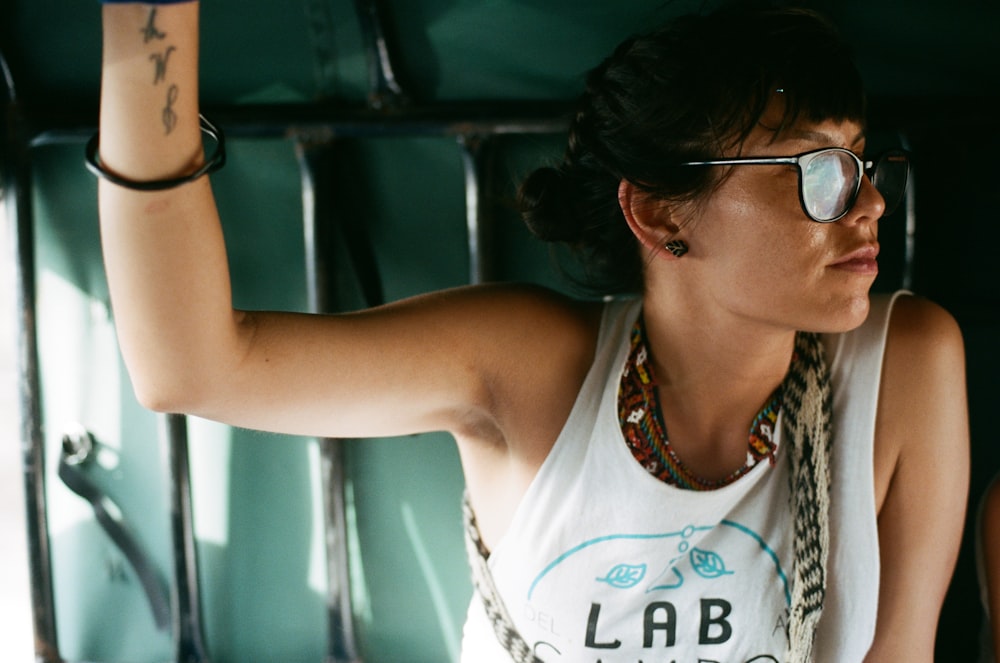 woman in white tank top wearing eyeglasses