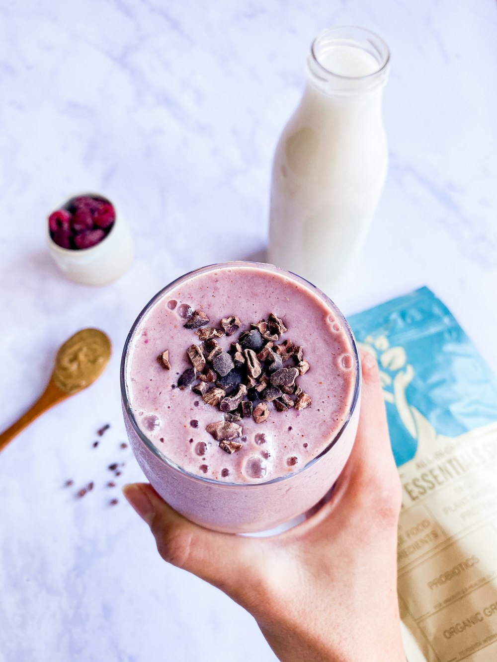 person holding cup of coffee with berries