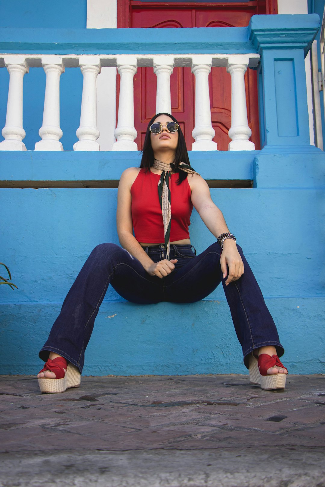 woman in blue tank top and black pants sitting on floor