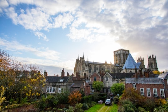 brown and gray concrete building under white clouds and blue sky during daytime in York Minster United Kingdom