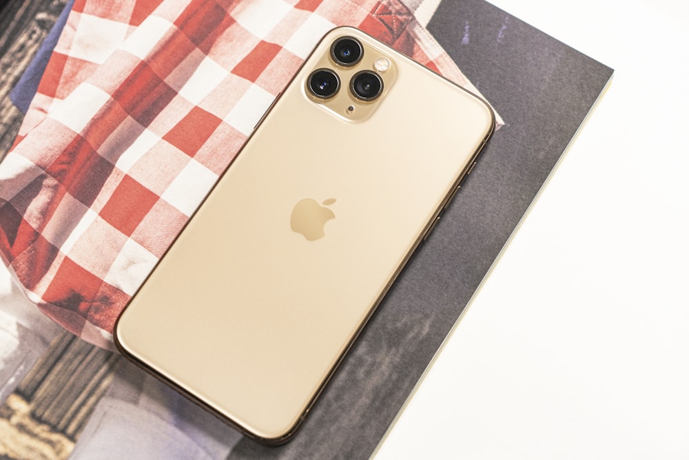 iPhone 6 dorado sobre tela a cuadros blancos, rojos y azules