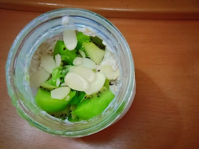 Close-up of a healthy overnight oats jar with berries and nuts.