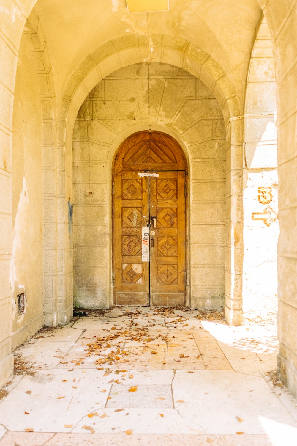 brown wooden door on beige concrete building