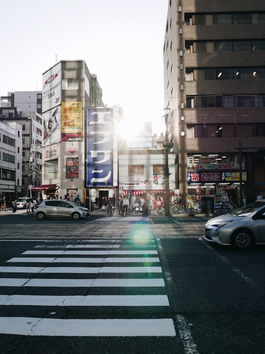 cars on road near high rise buildings during daytime in Hiroshima Japan