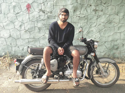 A motorcycle covered by insurance papers with a confident rider.